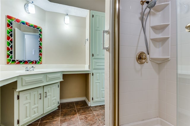 bathroom featuring vanity and tiled shower