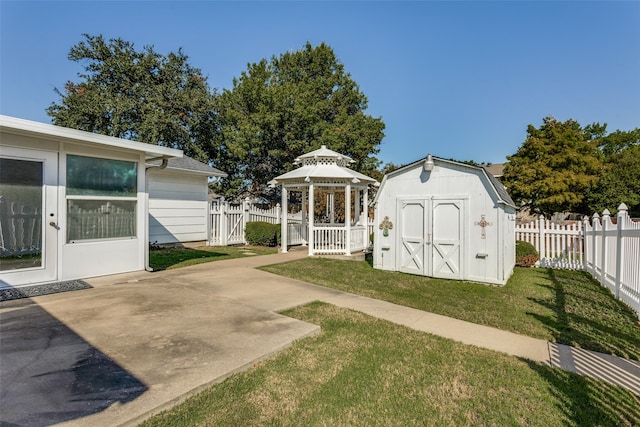 view of yard with a gazebo, a patio area, and a shed