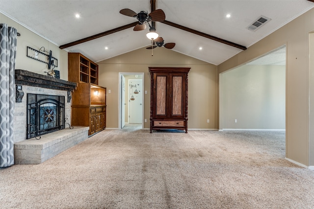 unfurnished living room with carpet, ceiling fan, crown molding, a fireplace, and vaulted ceiling with beams