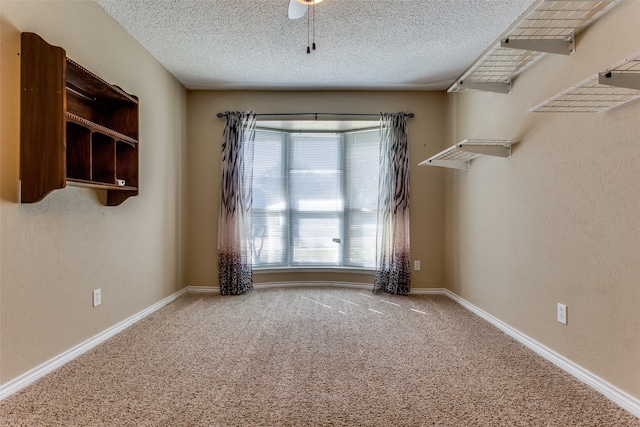 unfurnished room with carpet floors and a textured ceiling