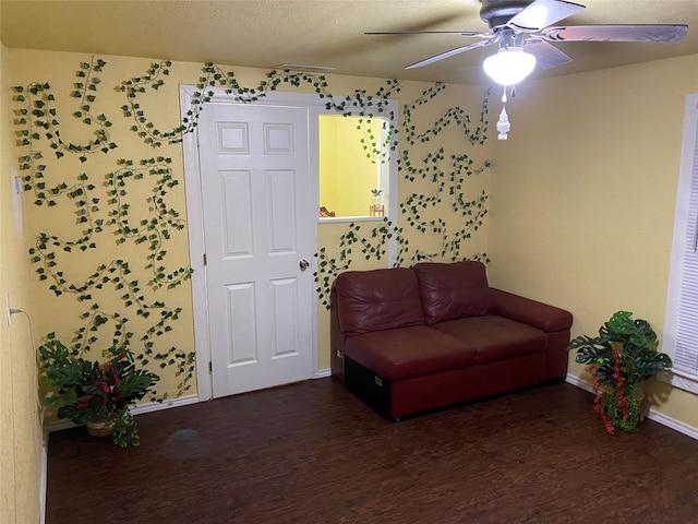 living area featuring a textured ceiling, ceiling fan, and dark hardwood / wood-style floors