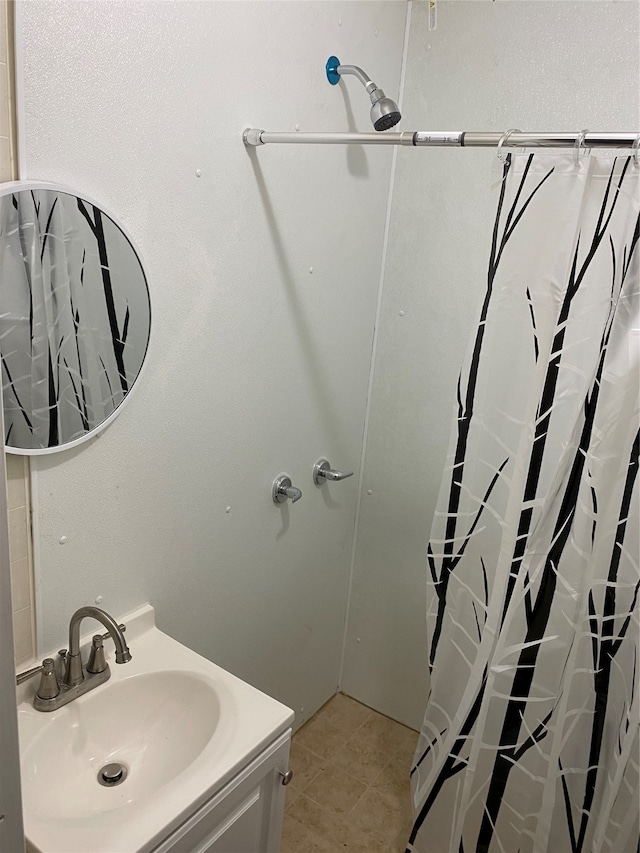 bathroom featuring tile patterned flooring, vanity, and a shower with shower curtain