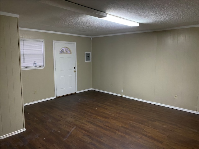 entryway featuring wooden walls, a textured ceiling, dark hardwood / wood-style floors, and crown molding