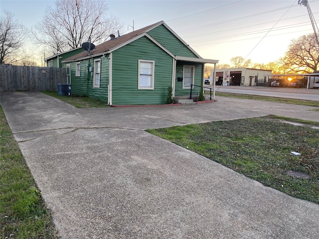 bungalow-style house with central air condition unit