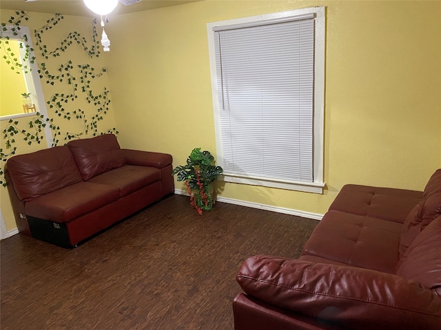 living room with ceiling fan and dark hardwood / wood-style flooring