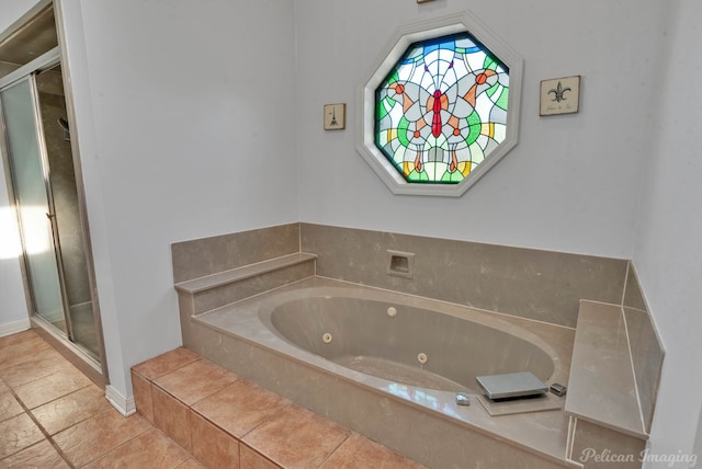 bathroom with a relaxing tiled tub