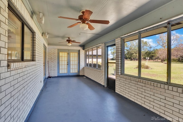 unfurnished sunroom featuring ceiling fan