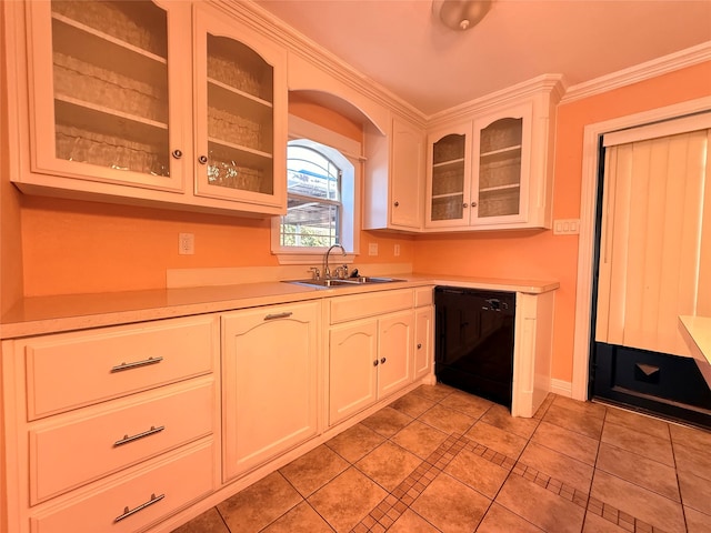 kitchen featuring sink, ornamental molding, black dishwasher, light tile patterned flooring, and white cabinetry