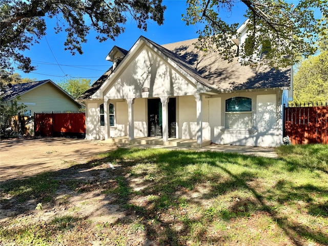 view of front of home with a porch and a front yard