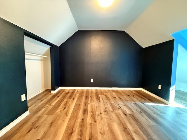 bonus room with light hardwood / wood-style floors and lofted ceiling