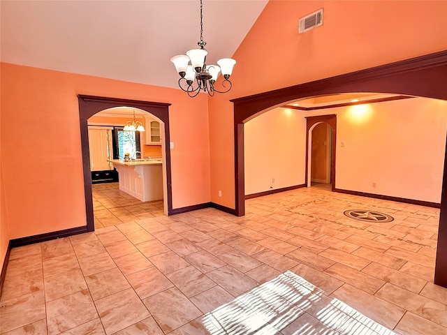 unfurnished room with sink, high vaulted ceiling, and an inviting chandelier