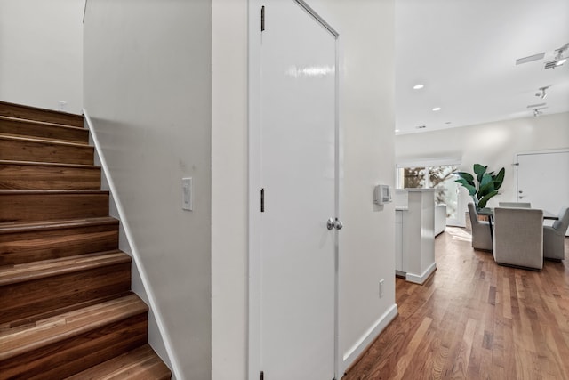 stairs featuring hardwood / wood-style flooring