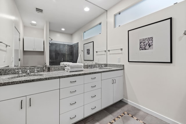 bathroom with tile patterned flooring, vanity, and an enclosed shower