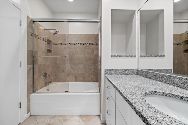 bathroom with combined bath / shower with glass door and vanity