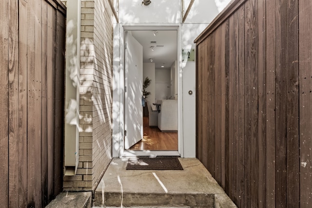 hallway featuring wood walls