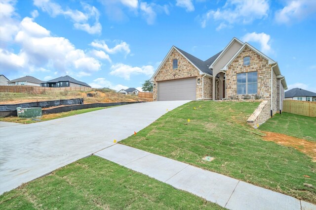 view of front facade with a front yard and a garage