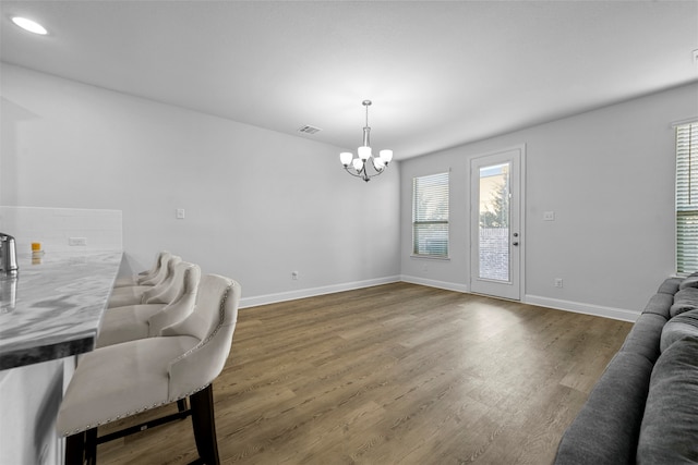 living room featuring a chandelier and dark hardwood / wood-style floors