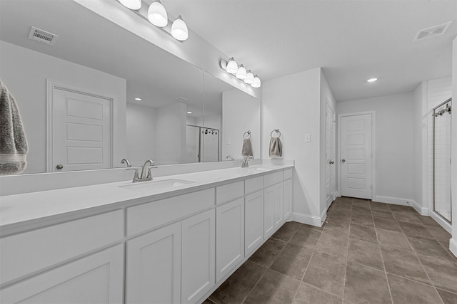 bathroom featuring vanity, tile patterned floors, and a shower with shower door