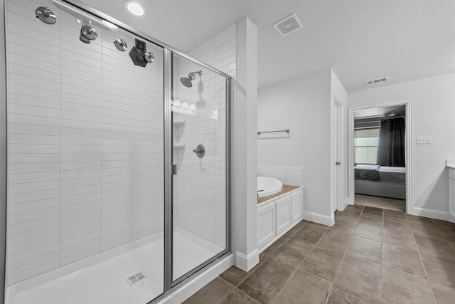 bathroom featuring tile patterned floors and shower with separate bathtub