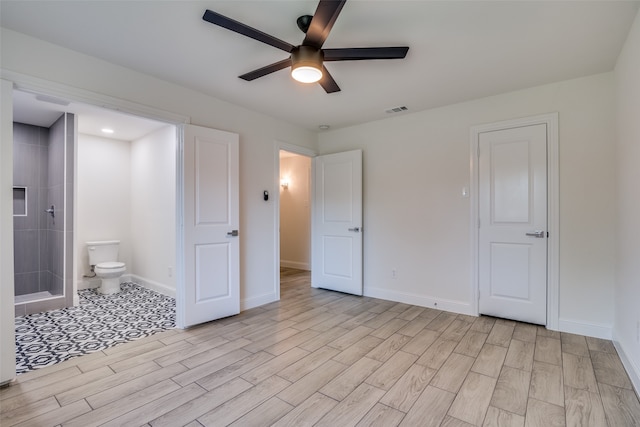 unfurnished bedroom with ceiling fan, light hardwood / wood-style floors, and connected bathroom