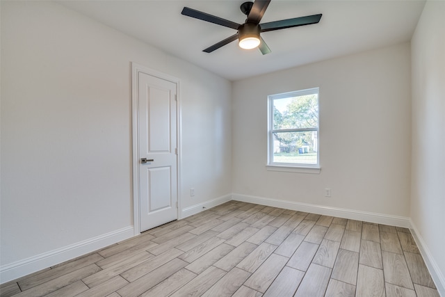 empty room with ceiling fan and light hardwood / wood-style floors