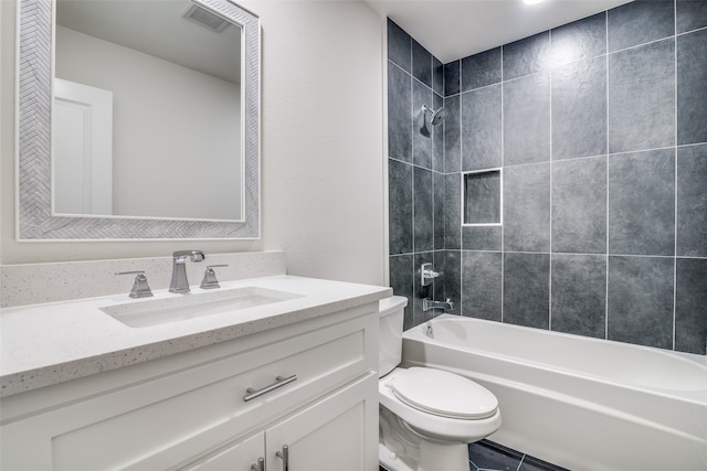 full bathroom featuring tiled shower / bath combo, toilet, and vanity