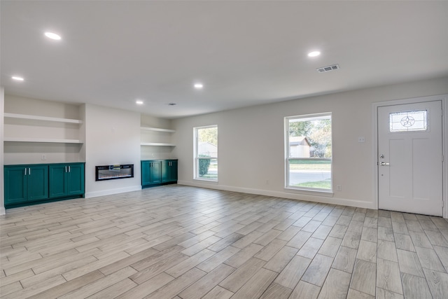 unfurnished living room featuring light hardwood / wood-style flooring