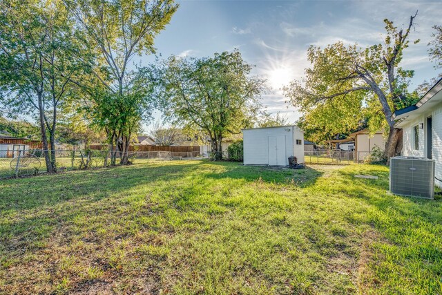 view of yard with a shed and central AC