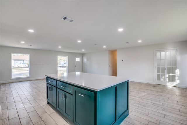 kitchen with a kitchen island and light hardwood / wood-style flooring