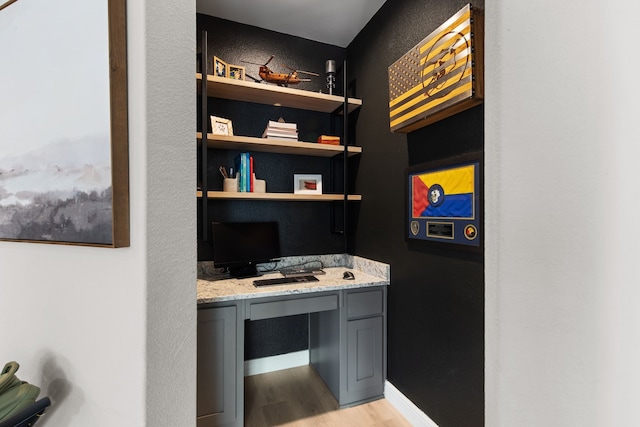 office featuring light wood-type flooring and built in desk