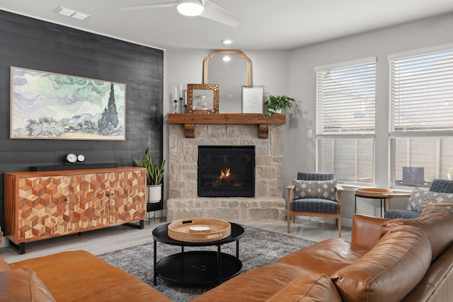 living room featuring hardwood / wood-style floors and a stone fireplace