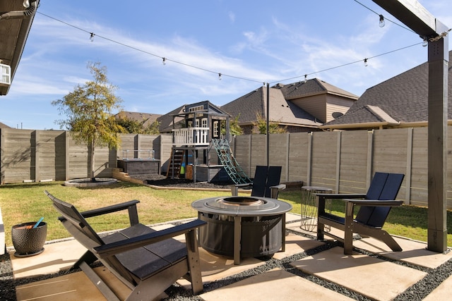 view of patio / terrace with a fire pit and a playground