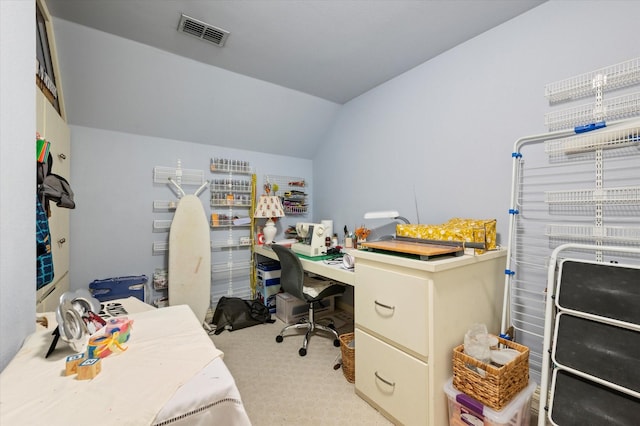 carpeted office space with vaulted ceiling