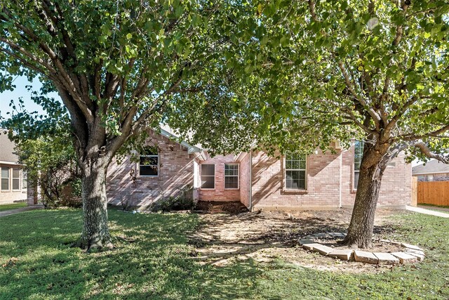 obstructed view of property featuring a front lawn