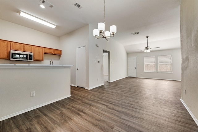 kitchen with dark hardwood / wood-style flooring, decorative light fixtures, ceiling fan with notable chandelier, and lofted ceiling