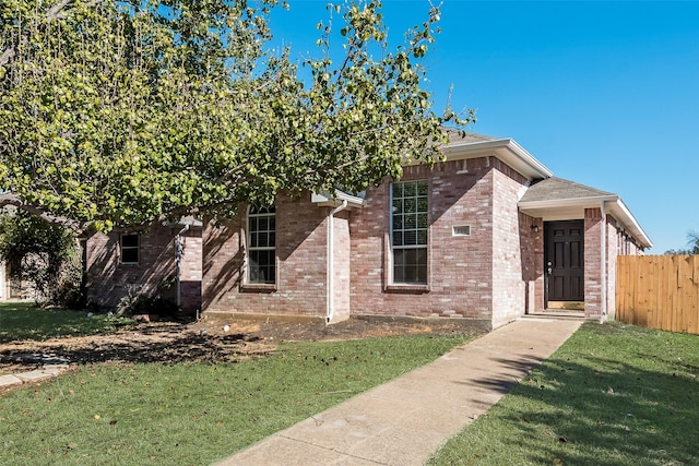 obstructed view of property featuring a front yard