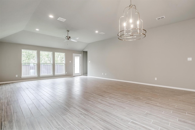 spare room featuring light hardwood / wood-style flooring, ceiling fan with notable chandelier, and lofted ceiling