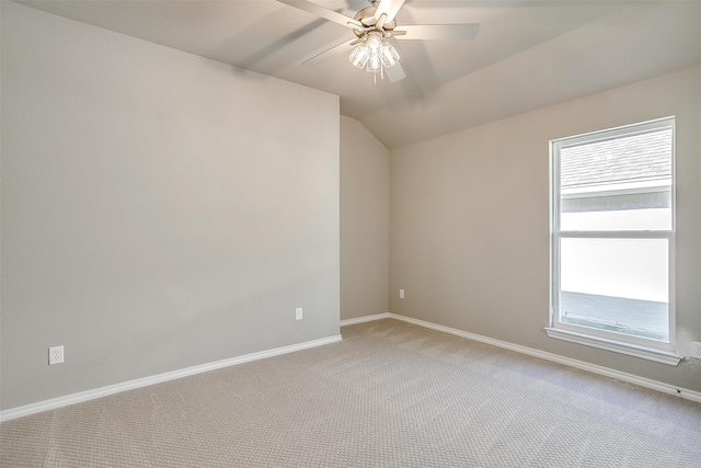 carpeted empty room with ceiling fan and vaulted ceiling