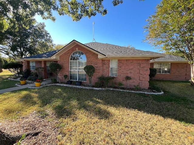 single story home featuring a front yard