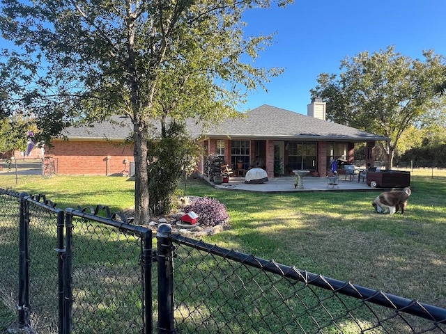 back of property featuring a lawn and a patio