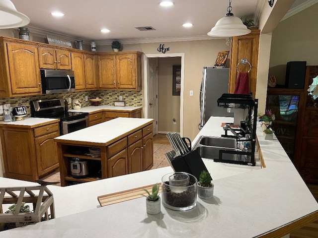 kitchen with crown molding, stainless steel appliances, hanging light fixtures, and tasteful backsplash