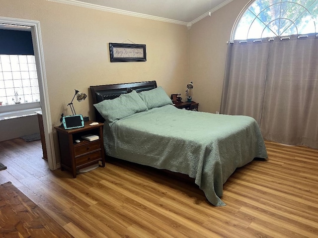 bedroom featuring light hardwood / wood-style floors and ornamental molding