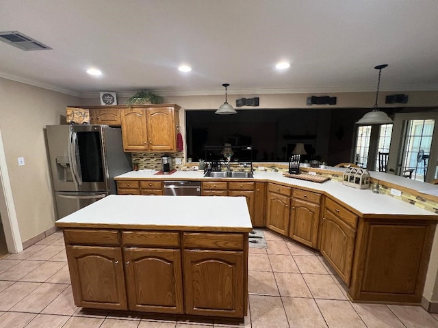 kitchen featuring kitchen peninsula, pendant lighting, and appliances with stainless steel finishes