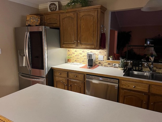 kitchen featuring decorative backsplash, ornamental molding, sink, and appliances with stainless steel finishes