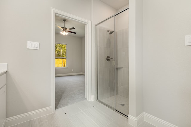 bathroom with tile patterned flooring, vanity, walk in shower, and ceiling fan