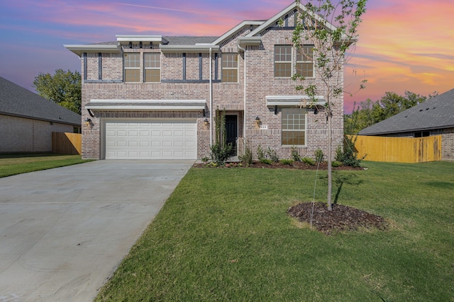 view of front of property featuring a garage and a yard