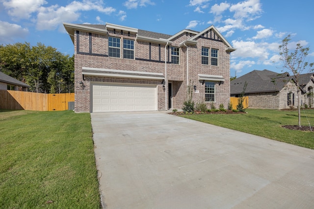 view of front of house featuring a front yard and a garage