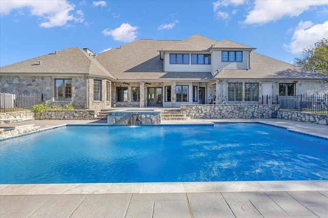 view of pool featuring pool water feature, a patio area, and an in ground hot tub