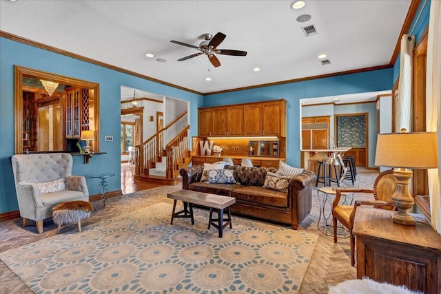 living room featuring ceiling fan and ornamental molding