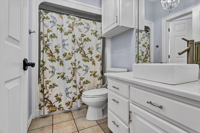 bathroom with tile patterned flooring, vanity, and toilet